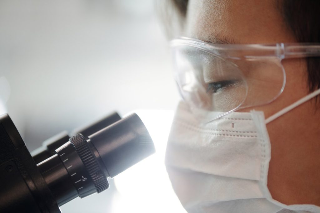 doctor looking through a microscope